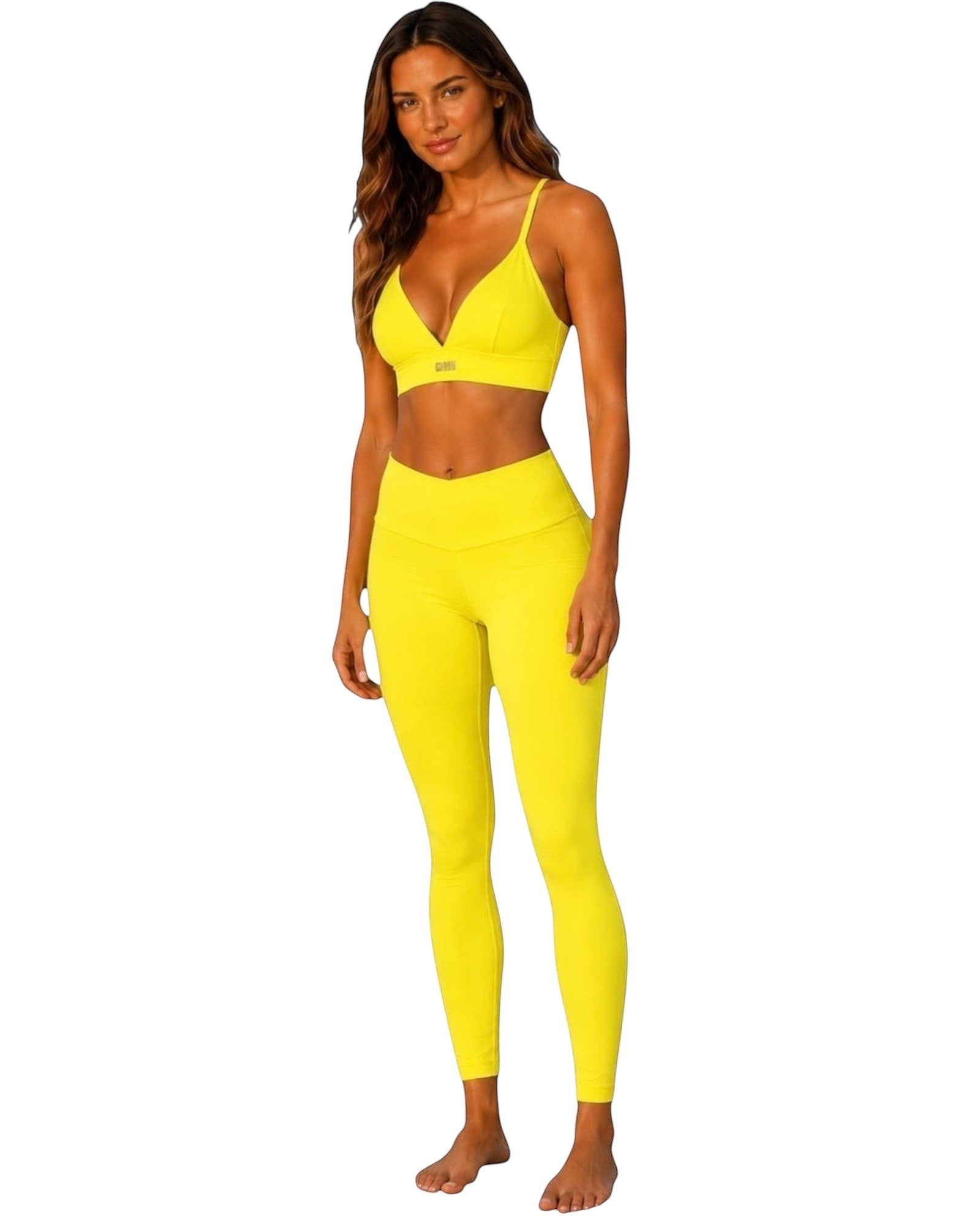 Phural Cardio to Cabana convertible bra-kini top in bright yellow worn by a model with matching leggings.