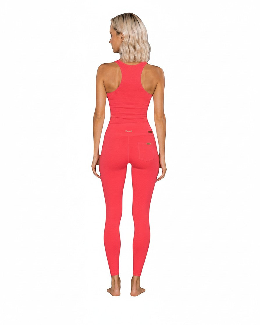 Phural She Did It Anyway Flares in Coral Riviera, a high-compression nylon-spandex performance fabric with back pockets.