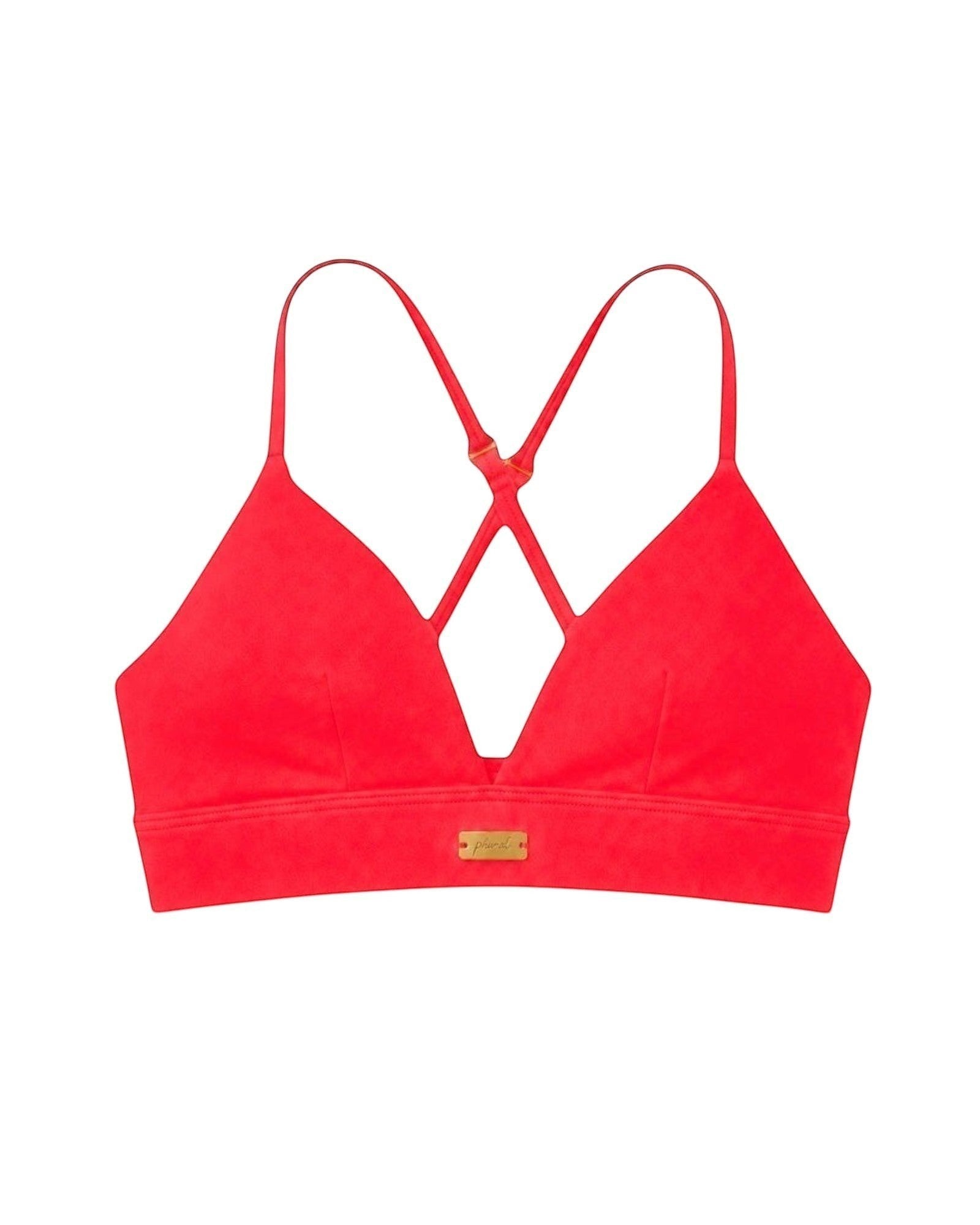 Phural red bikini top with cross-back straps and gold hardware detail, made from premium nylon-spandex fabric.