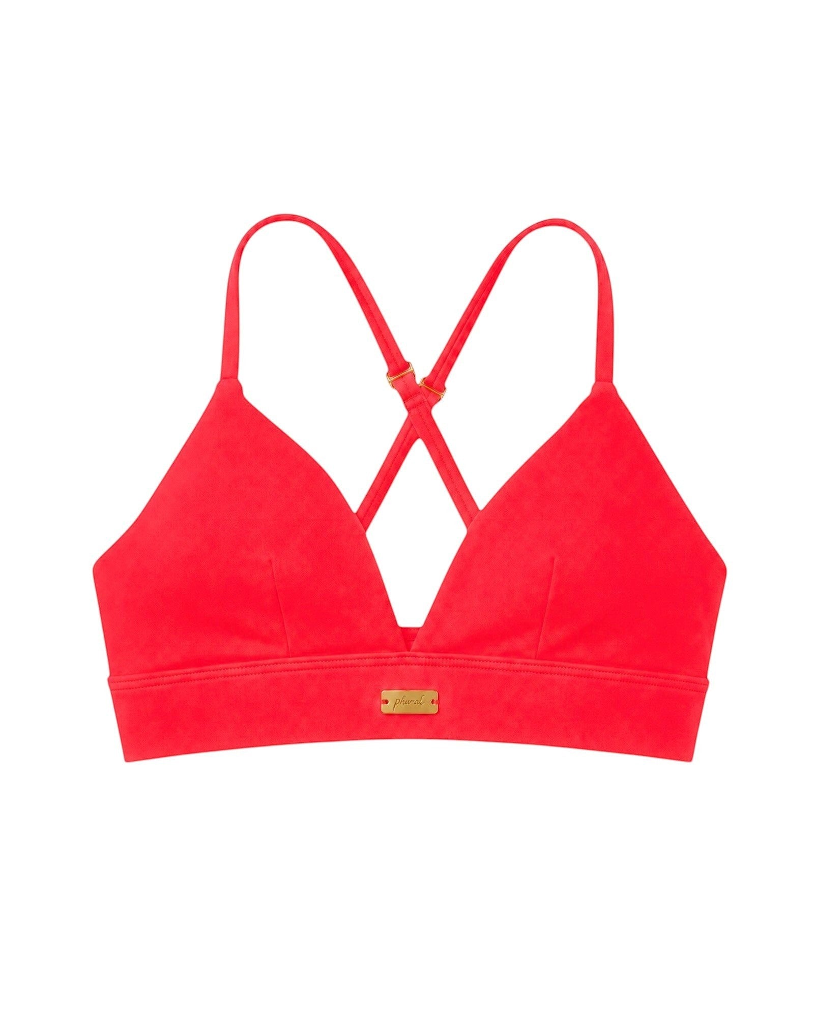 Phural red convertible bra-kini top with gold hardware, worn as a racerback sports bra or bikini top.