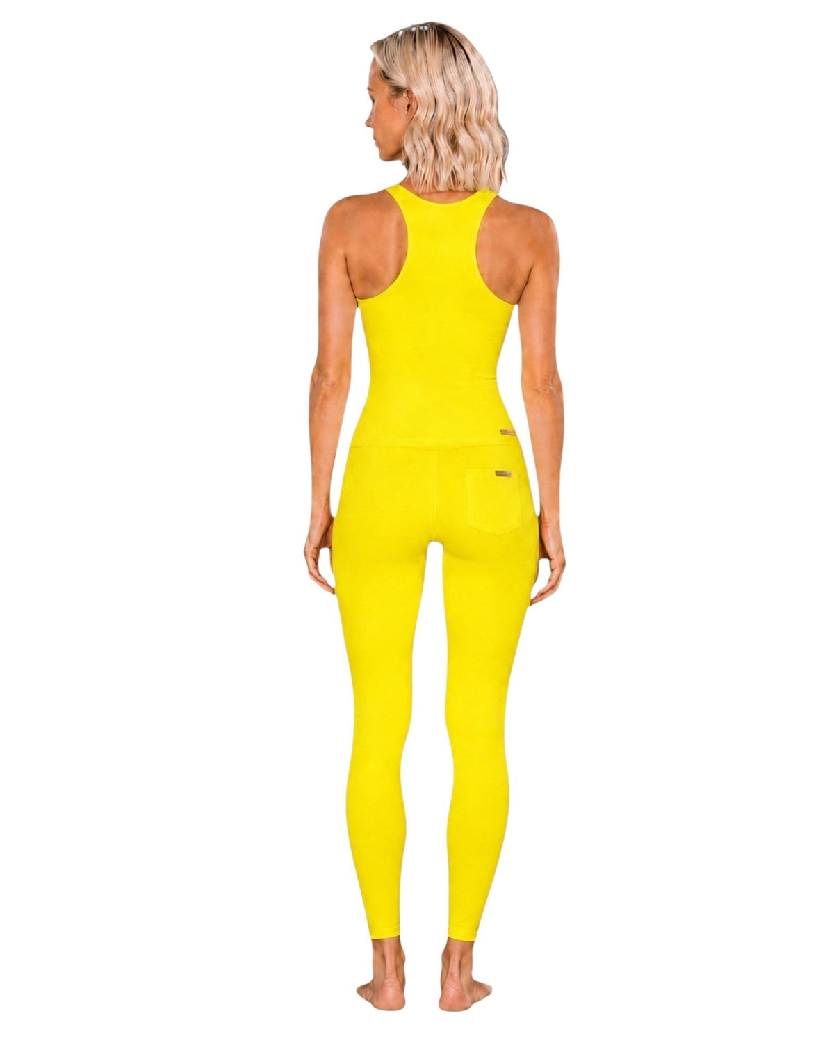 Phural She Did It Anyway Flares in Yacht Club Yellow, a high-compression nylon-spandex performance fabric with pockets.