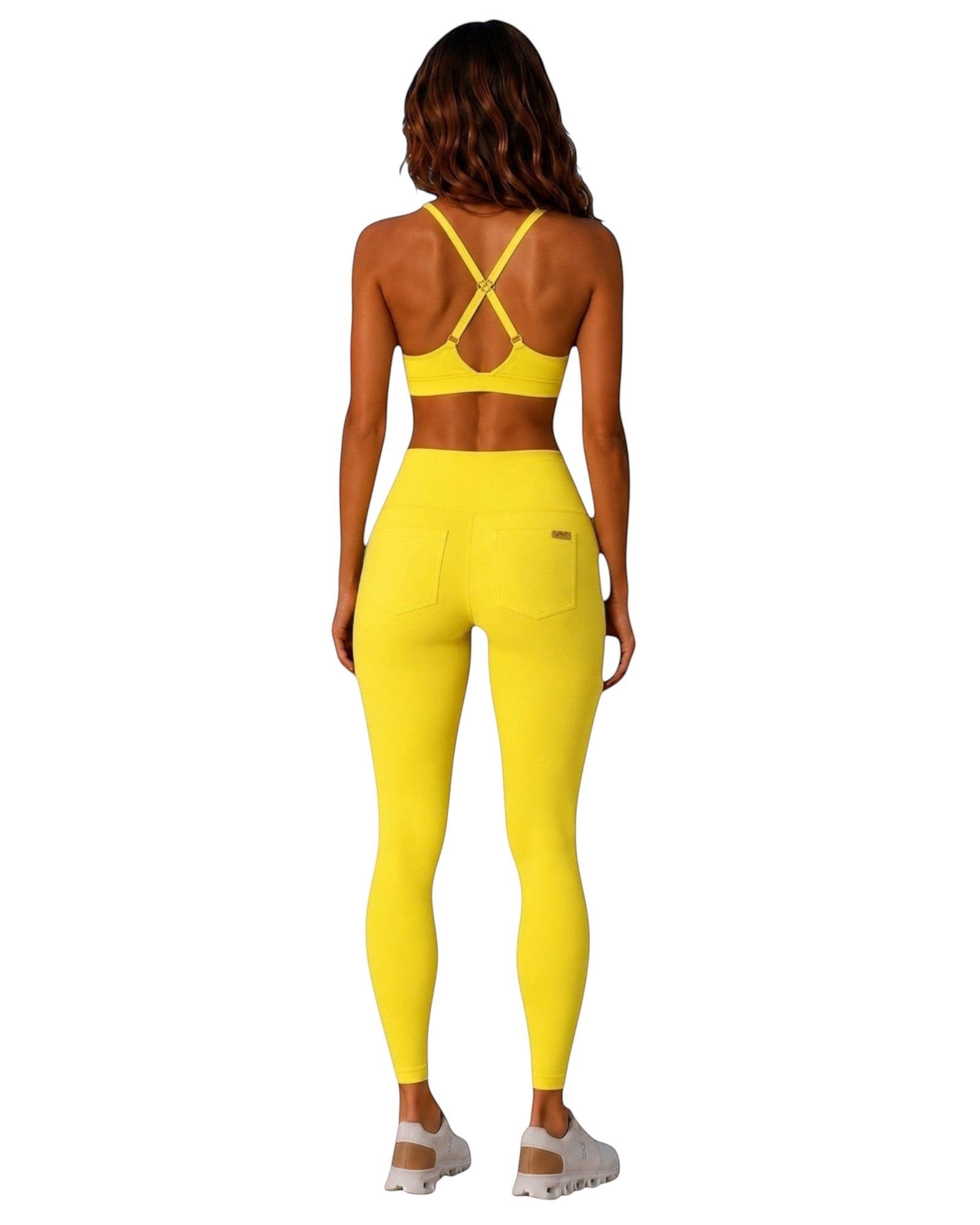 Phural Cardio to Cabana yellow racerback bra-kini top and matching high-waisted leggings worn by a woman from behind