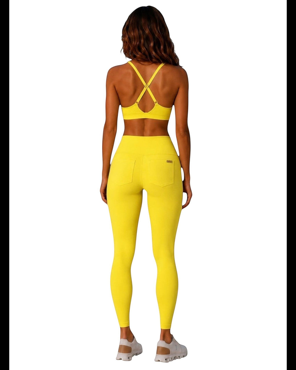Phural Cardio to Cabana yellow racerback bra-kini top and matching high-waisted leggings worn by a woman from behind