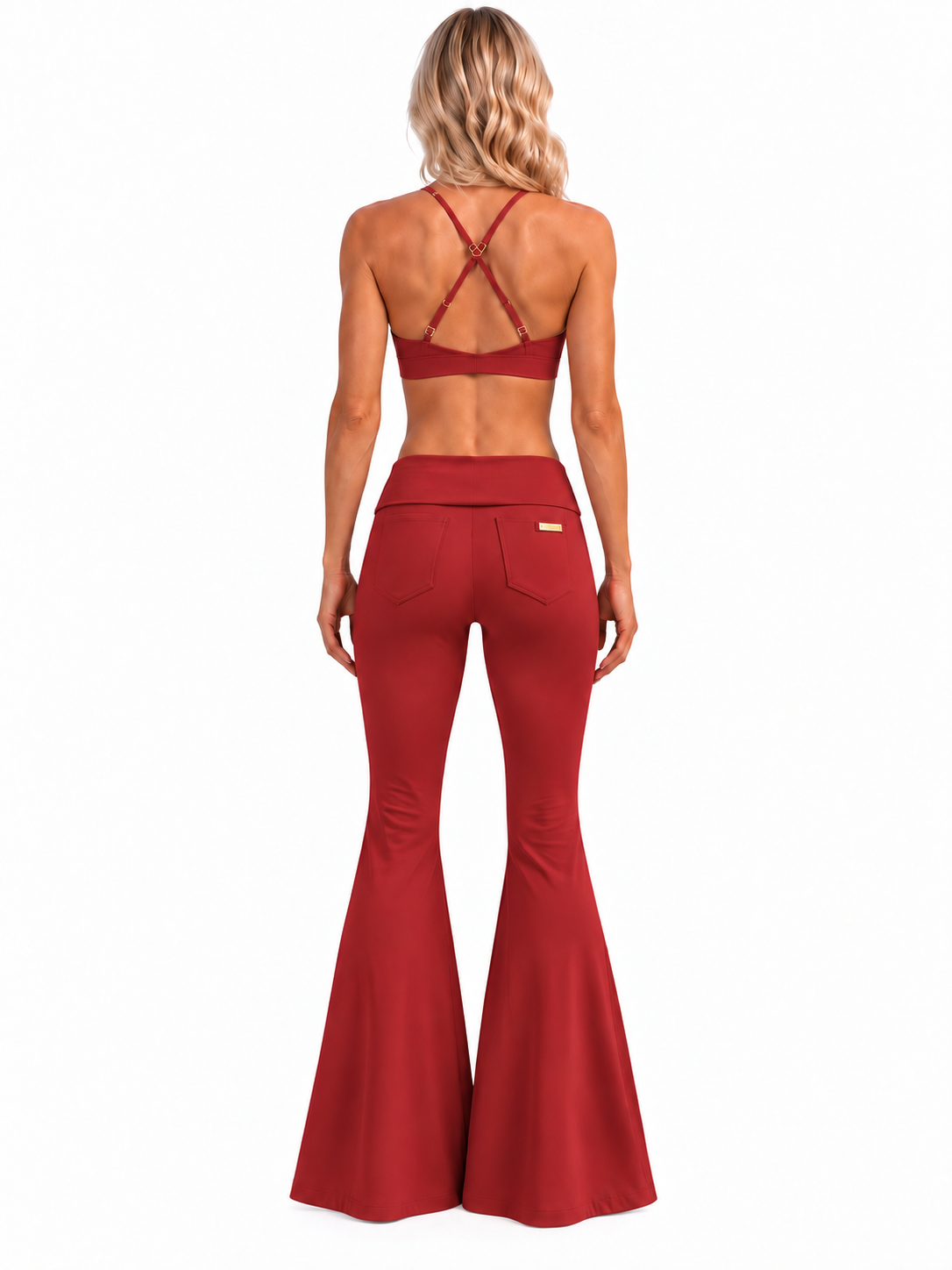 Rear view of Phural's blonde model in Rouge Noir She Did It Anyway Flares, showing the low-rise fold-over waistband, two back pockets and small gold tag.